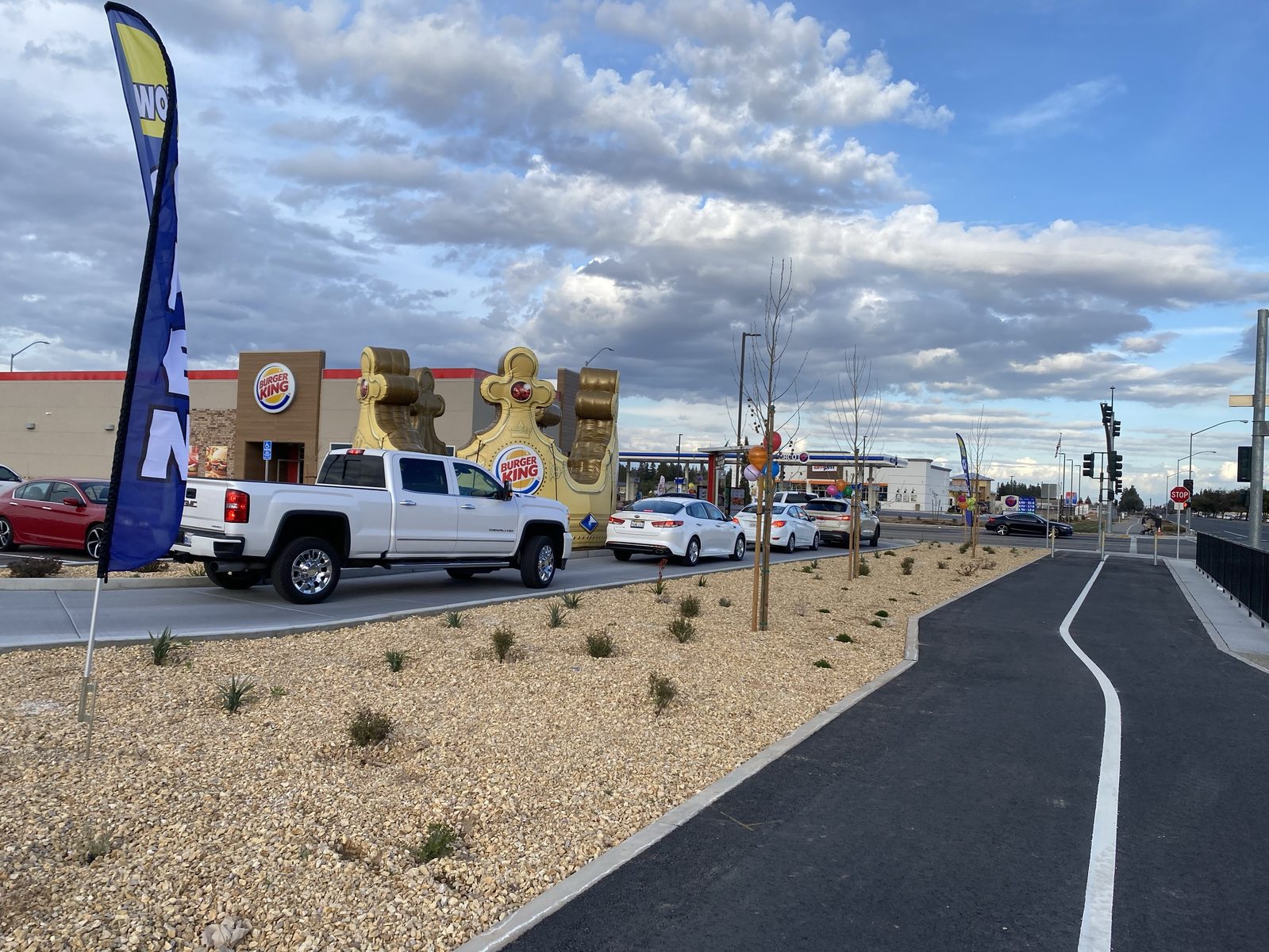 15 ft inflatable Burger King crown beside a drive-thru