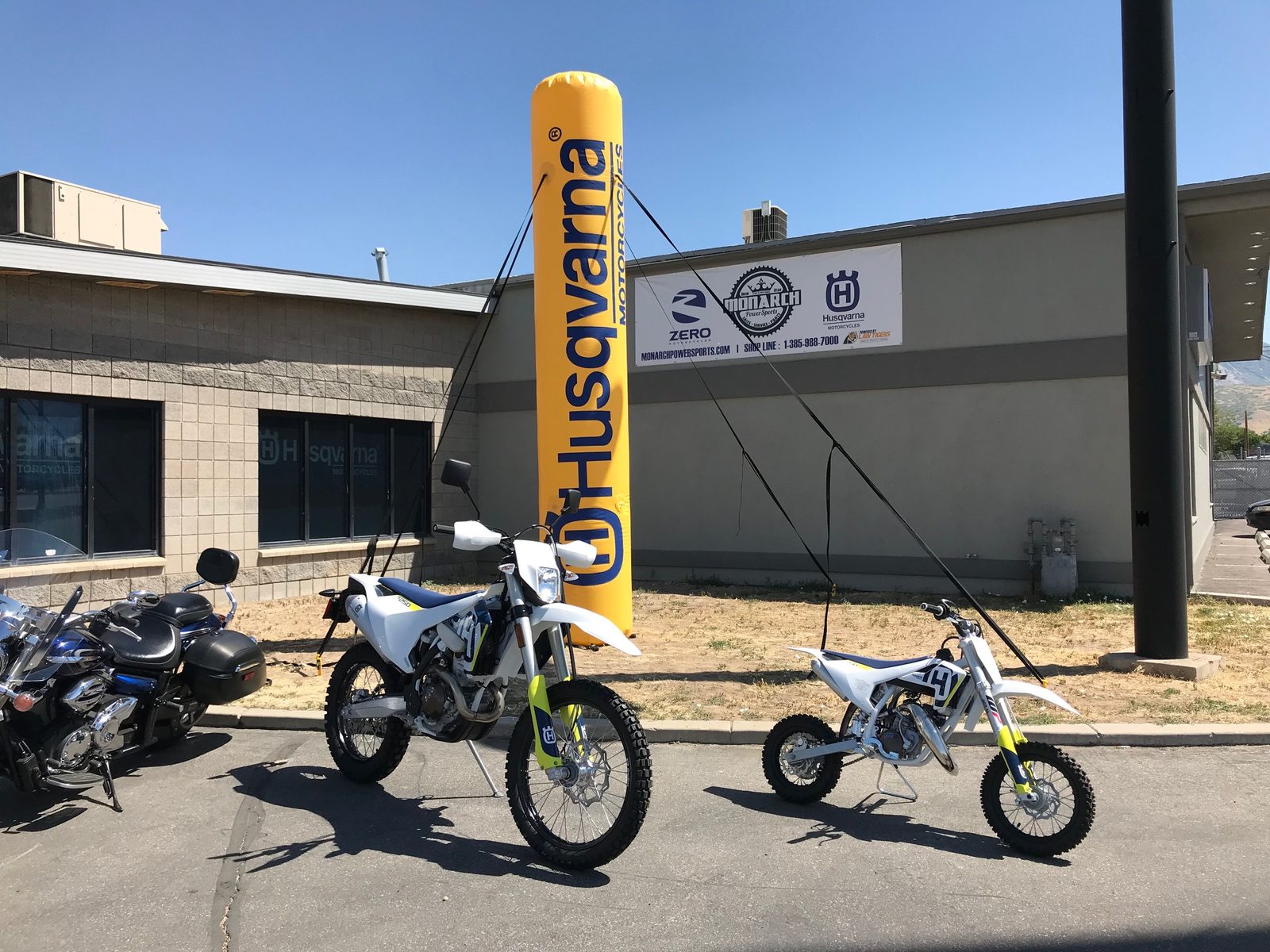 10 ft Husqvarna branded inflatable column in front of a motorcycle dealership